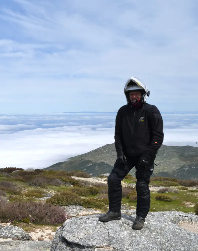 A person standing at the top of a mountain