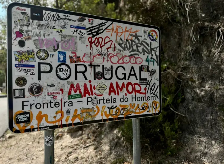 Portugal sign with lots of stickers on it