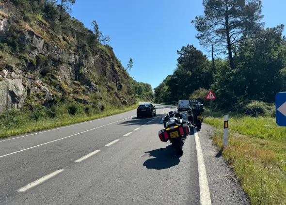 Motorbikes parked at the side of the road having broken down