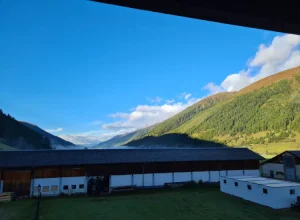 View over buildings at green mountain range